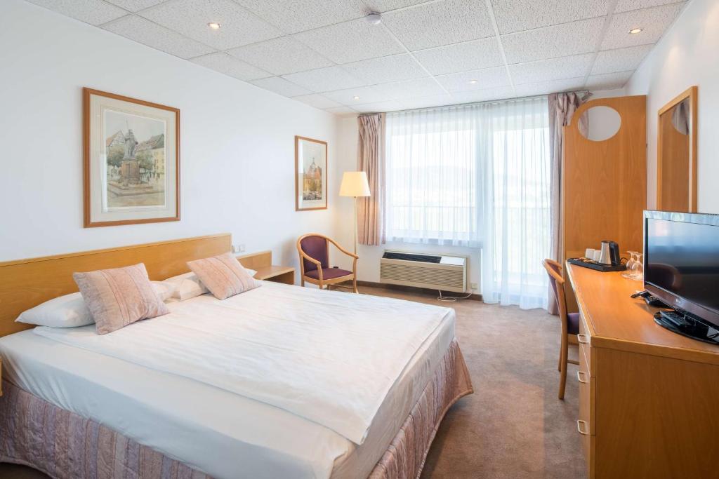 Postel nebo postele na pokoji v ubytování Best Western Hotel Jena