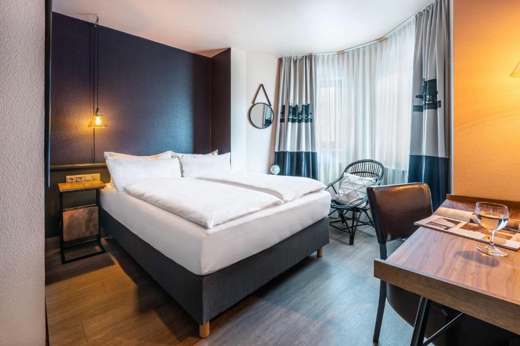 Postel nebo postele na pokoji v ubytování Best Western Hotel Nürnberg am Hauptbahnhof