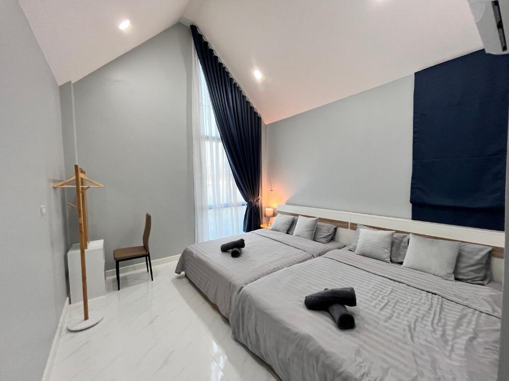 Postel nebo postele na pokoji v ubytování เชียงคานก๋อพูลวิลล่า CHIANG KHAN KOR POOL Villa
