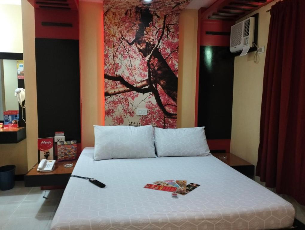 Postel nebo postele na pokoji v ubytování Hotel Sogo Quirino