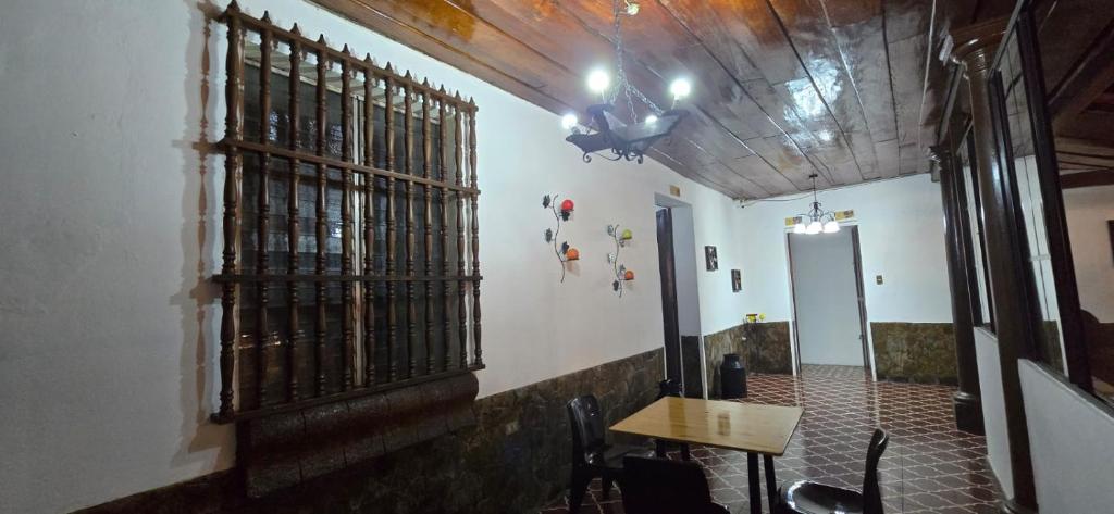 a room with a table and chairs and a ceiling at Antique Luna in Santa Ana