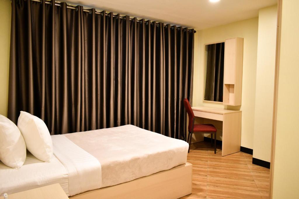 Postel nebo postele na pokoji v ubytování Olive Town Center and Hotel