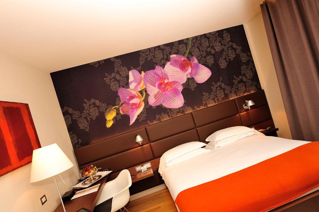 Cama ou camas em um quarto em Dal Moro Gallery Hotel