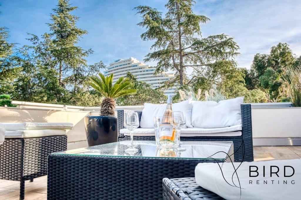 un patio avec une table et des chaises et un bâtiment dans l'établissement Ideal two-room apartment with a large terrace and parking, à Villeneuve-Loubet