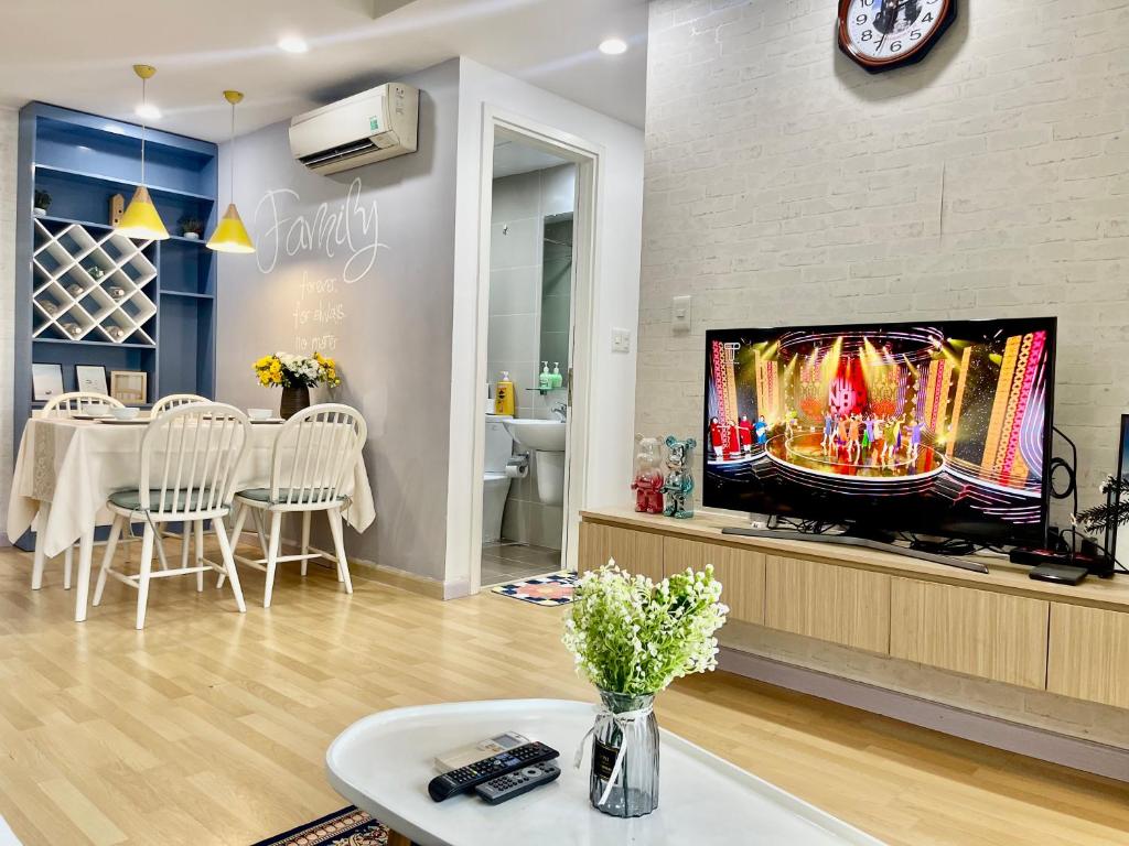 a living room with a flat screen tv on a wall at Capacious apartment 2 BRs in Masteri Thao Dien in Ho Chi Minh City