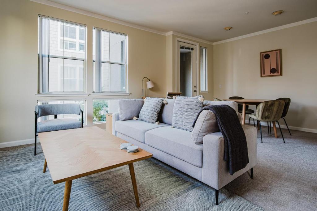 a living room with a couch and a table at Blueground San Mateo pool wd nr park SFO-1807 in San Francisco