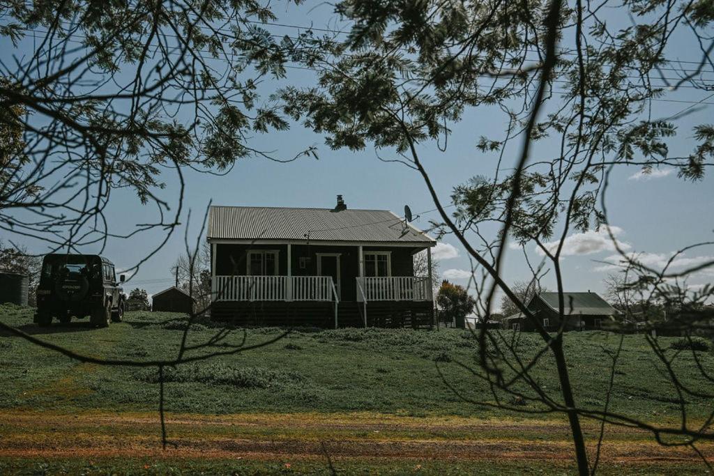 a small house in the middle of a field at Two Brothers' Cabin in Deeside