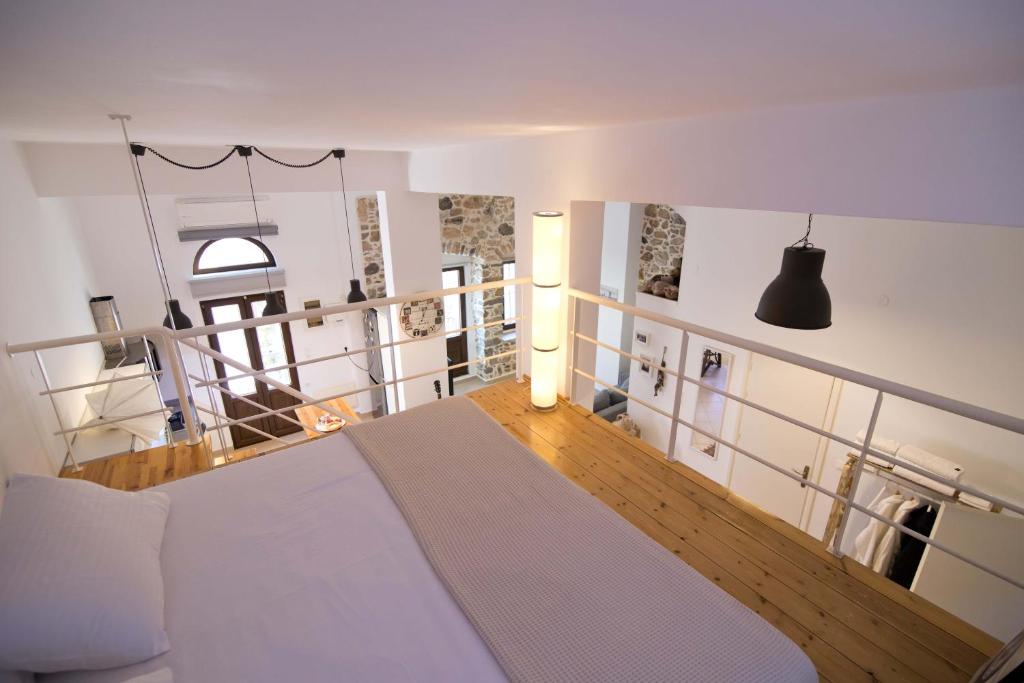 a bedroom with a large white bed in a room at FOTEINI RESIDENCE in Kalymnos