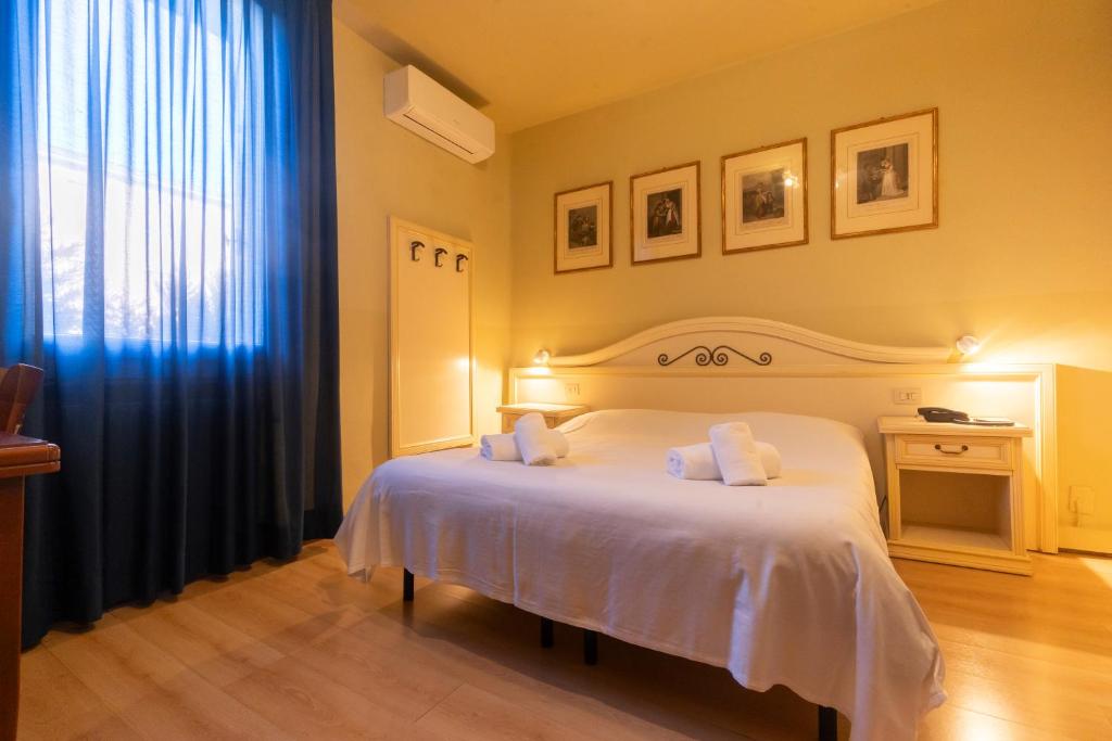 Postel nebo postele na pokoji v ubytování Hotel La Terrazza