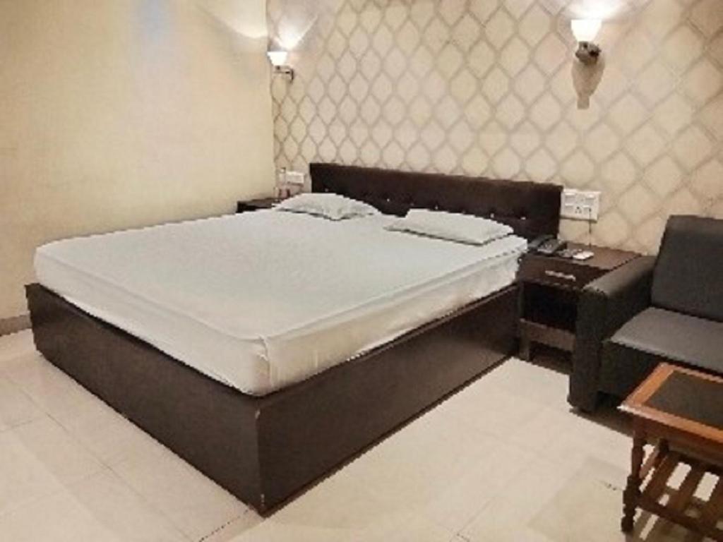 Postel nebo postele na pokoji v ubytování The Citi Residenci Hotel, Bidhannagar