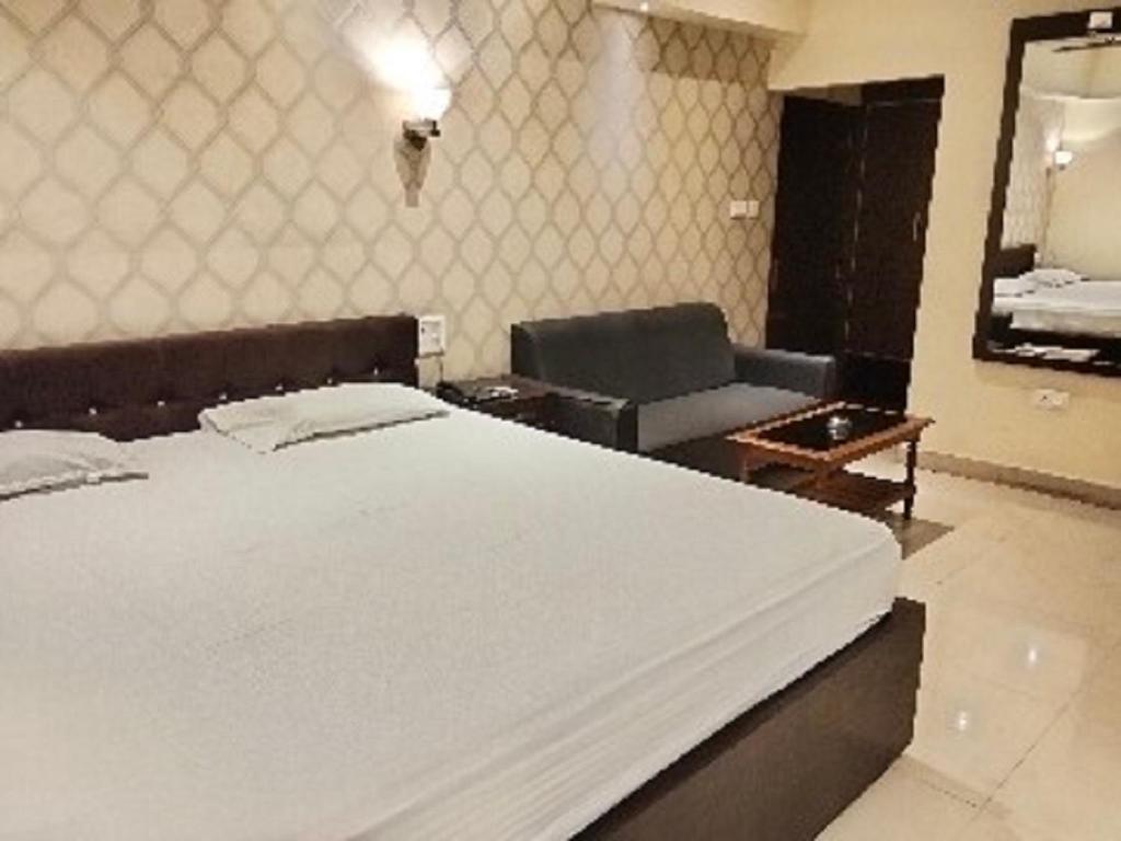 Postel nebo postele na pokoji v ubytování The Citi Residenci Hotel, Bidhannagar