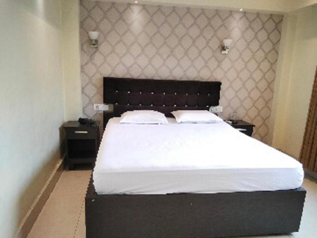 Postel nebo postele na pokoji v ubytování The Citi Residenci Hotel, Bidhannagar