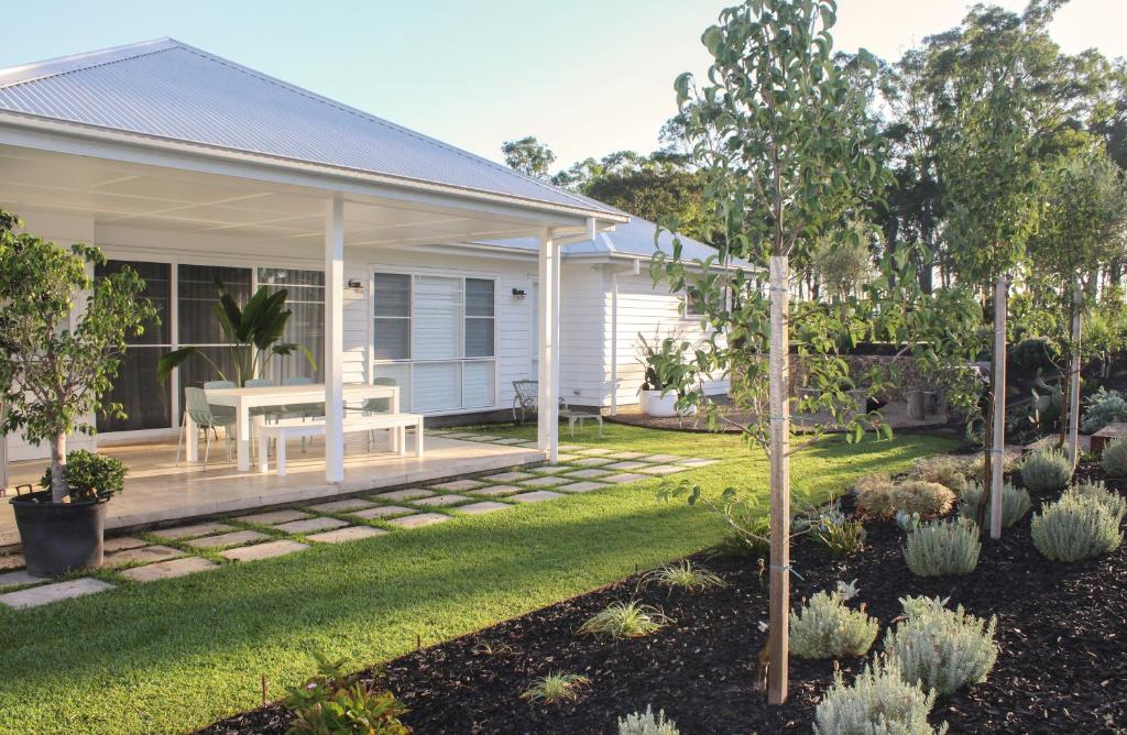 a house with a garden with a bench on a porch at Luxury house, close to weddings! in Worragee