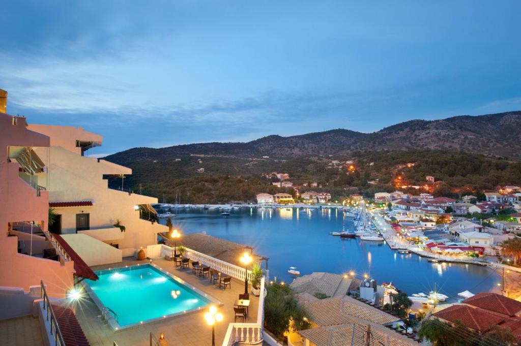 a view of a harbor at night with a pool at Panorama Botsaris Apartments in Syvota