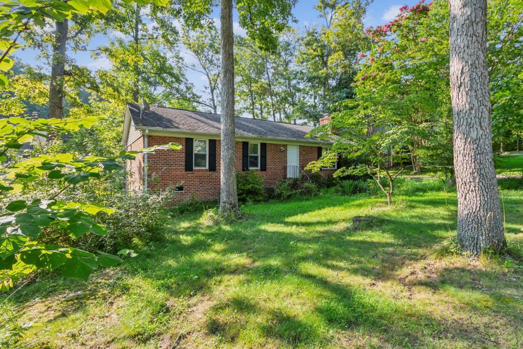 an old brick house in the woods with trees at Charming Family Retreat with Scenic Views home in Flat Run
