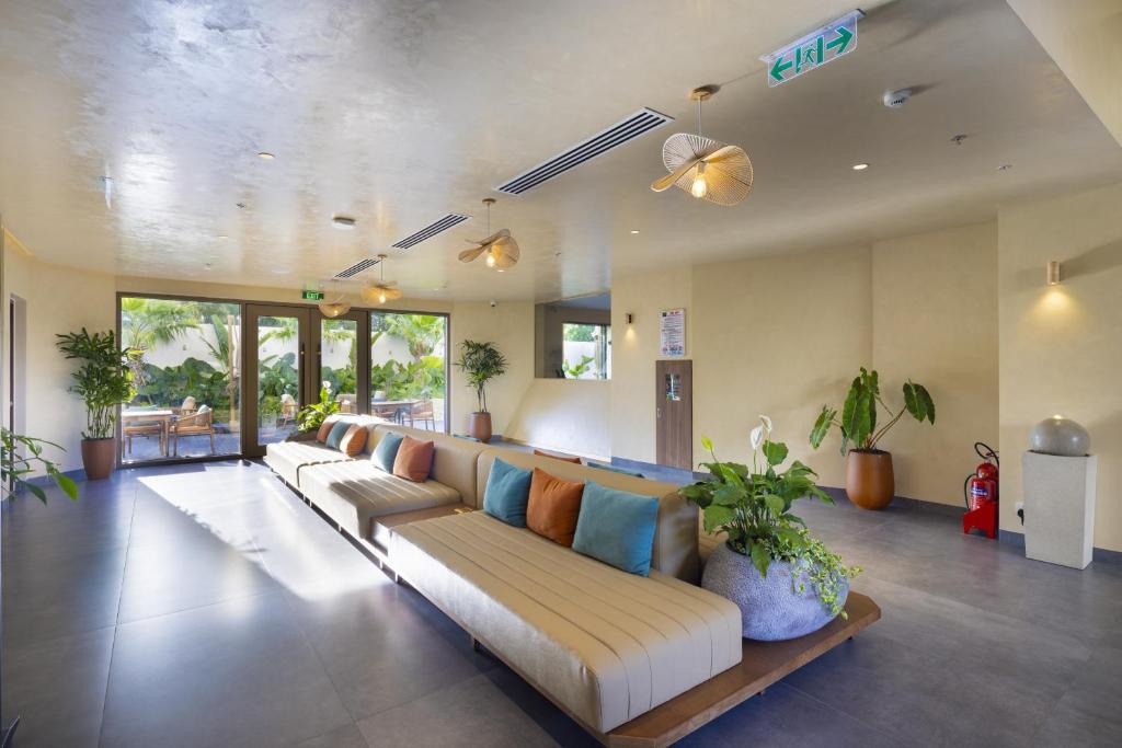 a large living room with a couch and some plants at Iconic Long Hai Hotel in Long Hai
