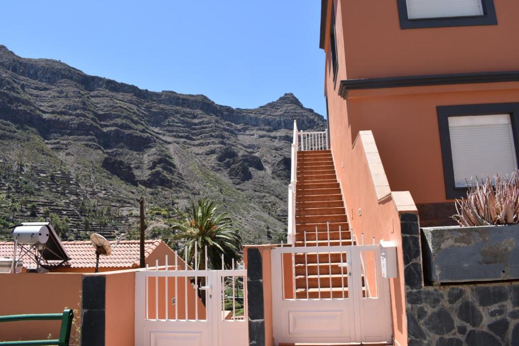 a house with a white gate and a mountain at Los Paredones 2 in Valle Gran Rey
