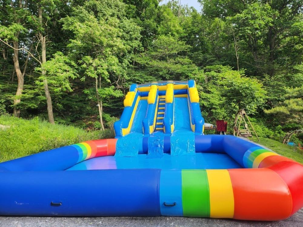 a colorful inflatable playground with a slide at Ganghwado Baba Valley Pension in Incheon