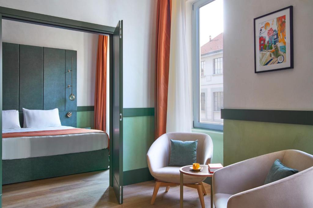 Postel nebo postele na pokoji v ubytování NEMI Hotel