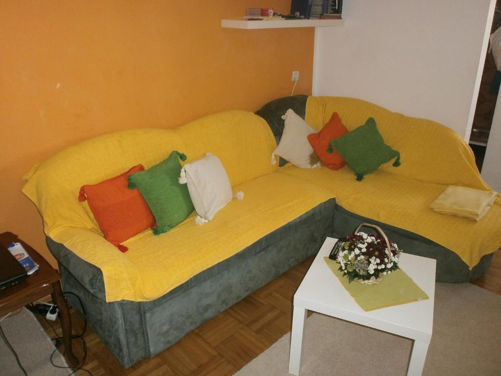 a couch with pillows on it in a living room at Apartment Iva in Bar