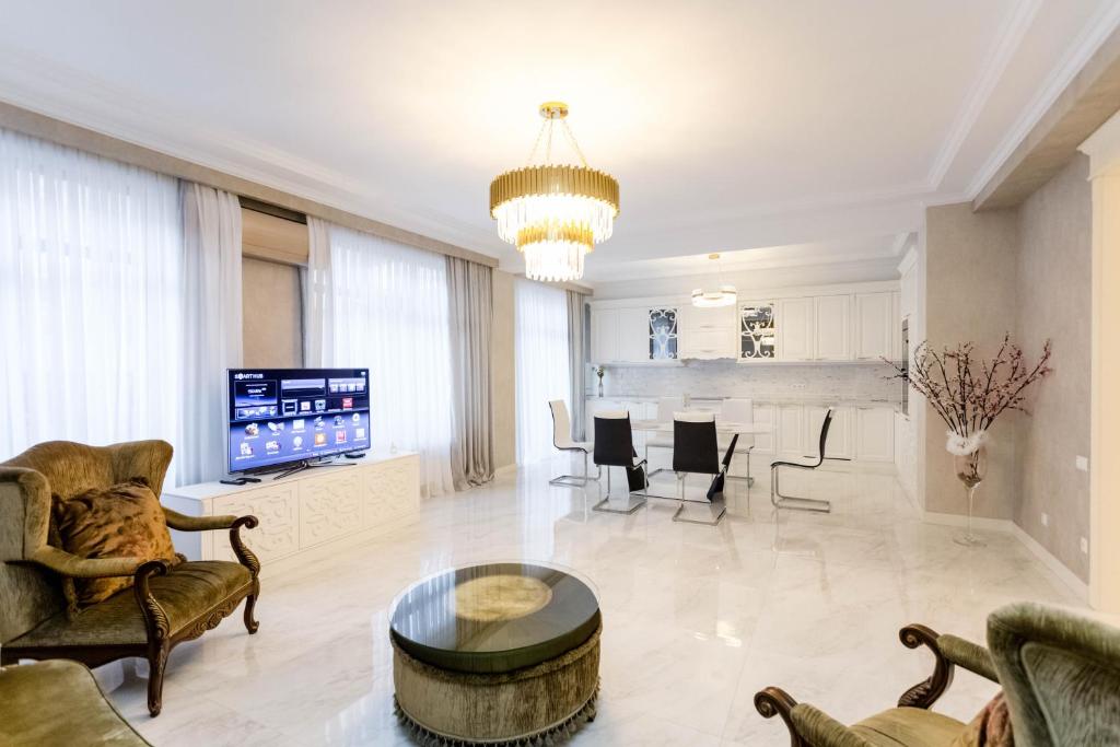 a living room with a couch and a table at Luxury Apartment For Families Or Group of Visitors In City Center I in Tbilisi City
