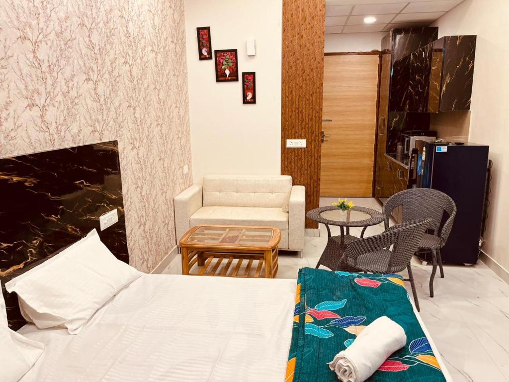 a living room with a couch and a table at Golden palace studio in Ghaziabad