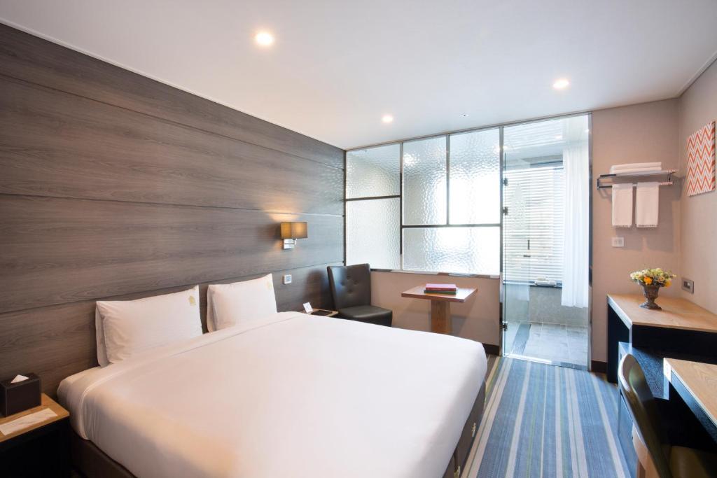 Postel nebo postele na pokoji v ubytování Benikea Hotel Haeundae