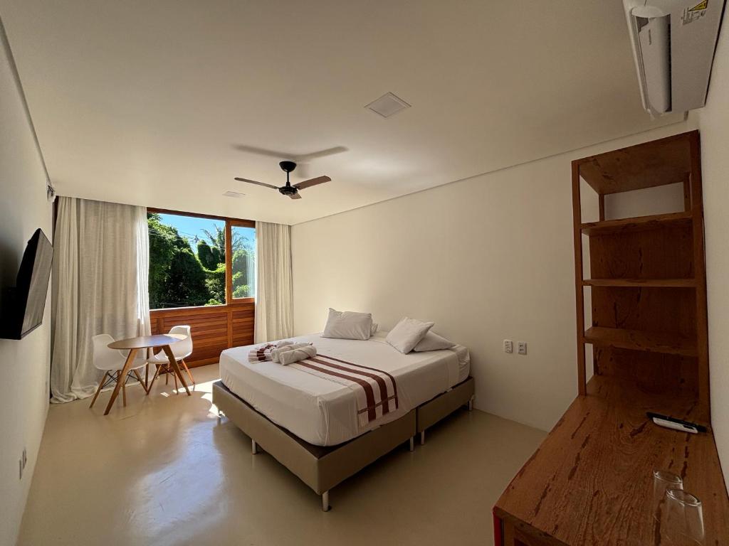 En eller flere senge i et værelse på POUSADA MEL DO CACAU