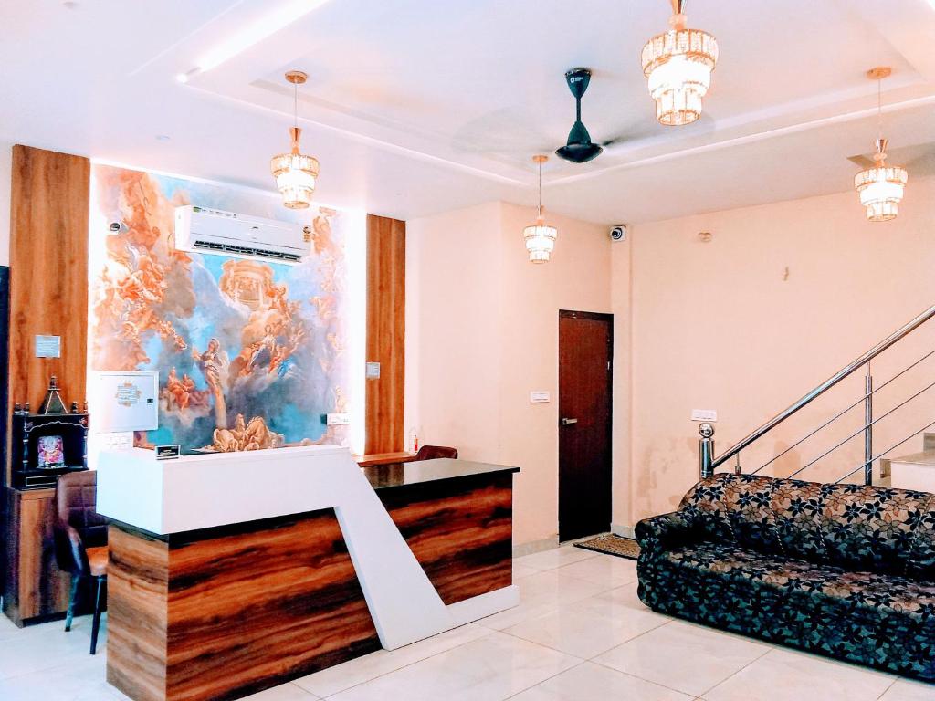 a living room with a staircase and a painting on the wall at Hotel Orio Castle in Ludhiana