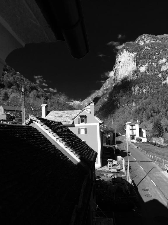 a black and white photo of buildings and a mountain at MyVerzasca Resort Ai piee in Brione