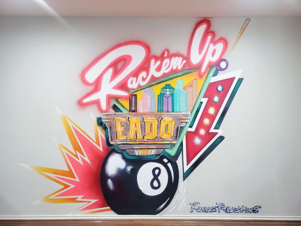 a sign on a wall with a bowling ball at EaDo Townhome Pool Table By Convention & Stadiums in Houston