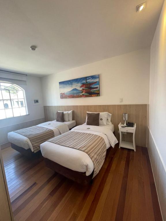 Postel nebo postele na pokoji v ubytování Casa Hotel Boyaca Real