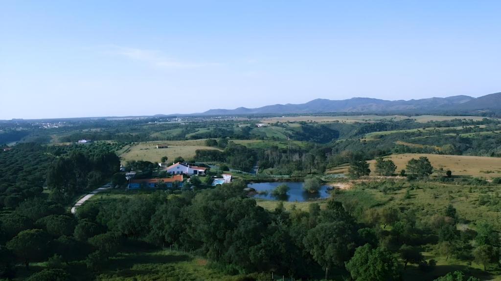 uma vista aérea de uma casa numa colina ao lado de um rio em Monte da Corça Nova em Vila Nova de Milfontes