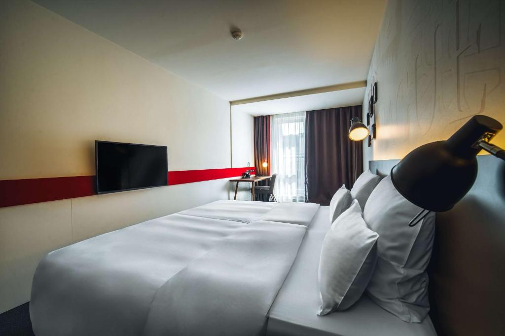 Postel nebo postele na pokoji v ubytování Pentahotel Prague