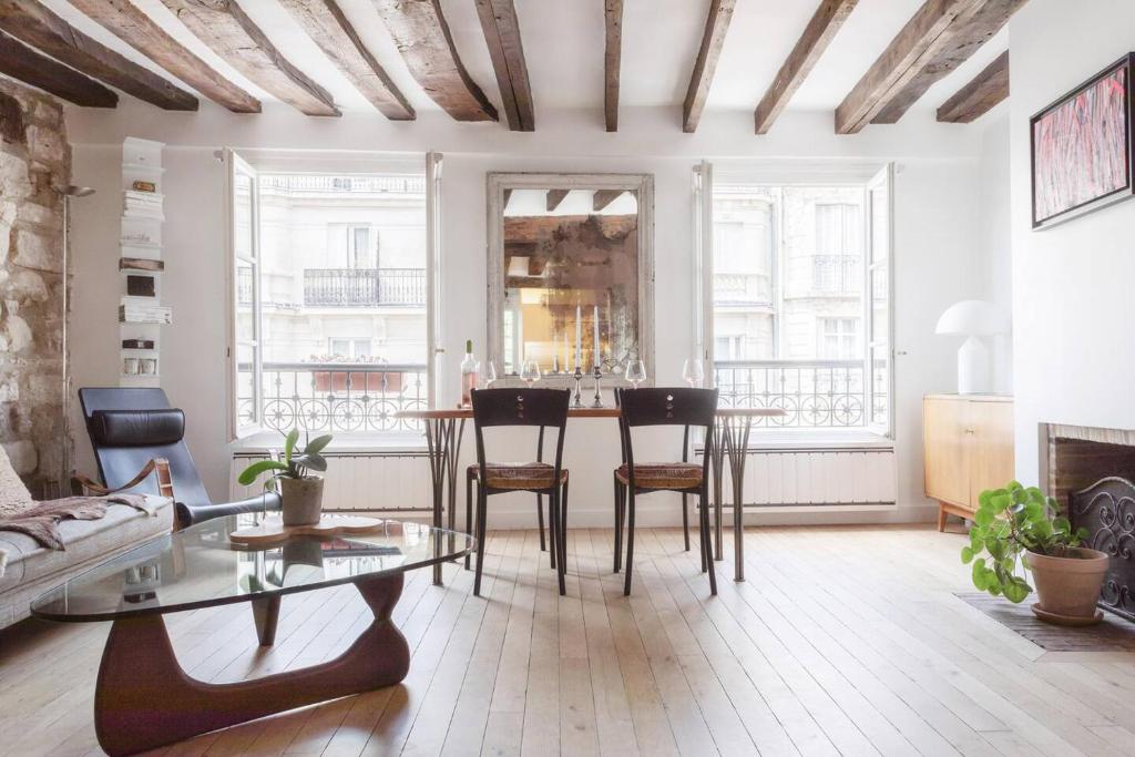 un salon avec une table et des chaises dans l'établissement Notre-Dame Stunning 2 BR air conditioned Flat, à Paris