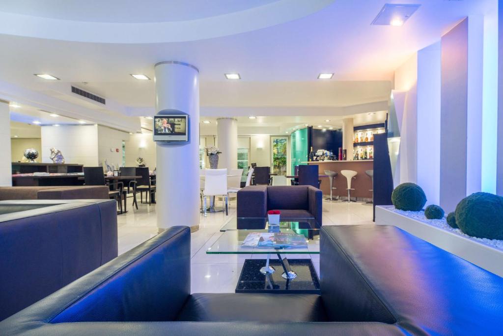 a lobby with a waiting room with chairs and a table at Best Western Plus Grand Hotel Victor Hugo in Luxembourg