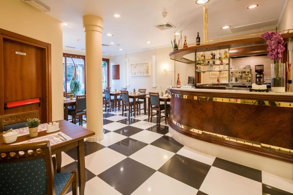 a restaurant with a black and white checkered floor at Best Western Plus Grand Hotel Victor Hugo in Luxembourg