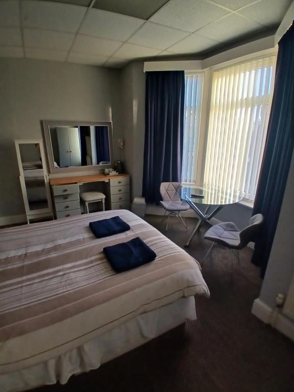 a hotel room with a bed and a television at The Kirkview in Blackpool