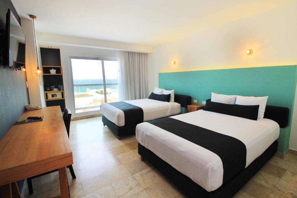 Postel nebo postele na pokoji v ubytování Rivoli Select Hotel