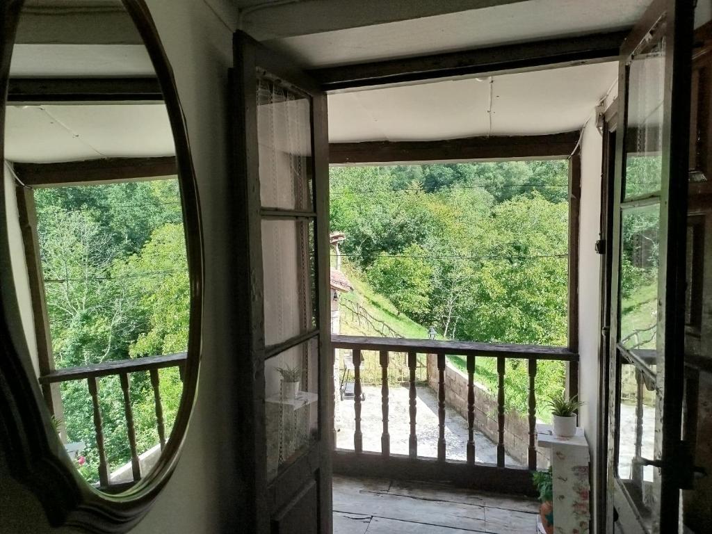 a room with a window looking out at a forest at El Pedrosu casa para 6 personas en Espinareu in Cuerrías