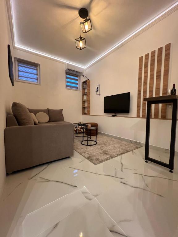 a living room with a couch and a flat screen tv at Apartman Ruzica in Trebinje