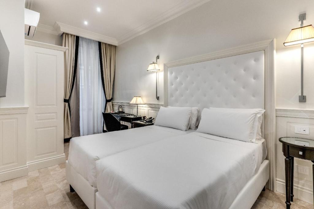 Postel nebo postele na pokoji v ubytování ACA Hotel Viminale