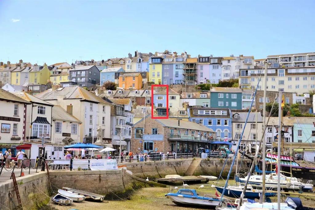 a group of boats docked in a harbor with buildings at Oyster Catcher Cottage - Harbour Bowl, Sea Views in Brixham