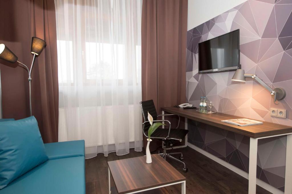 TV a/nebo společenská místnost v ubytování Best Western Hotel Braunschweig Seminarius