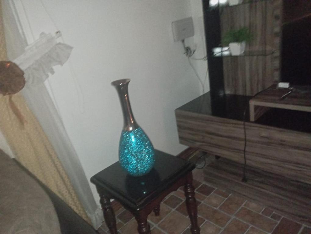 a blue vase sitting on a table in a room at Casa castro chiloe in Castro