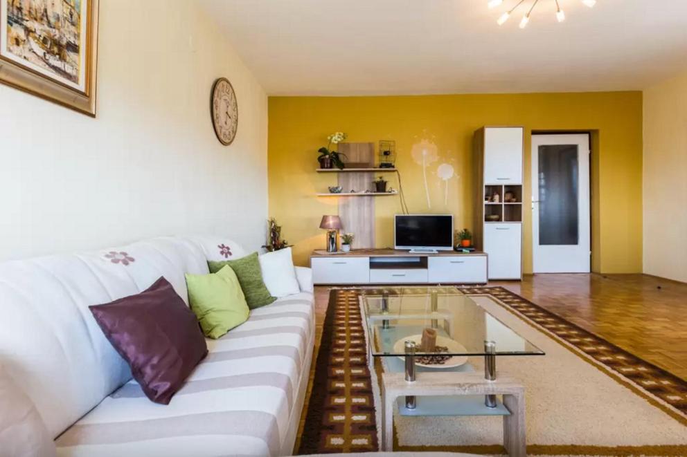 a living room with a white couch and a table at Apartment Maraska in Zadar