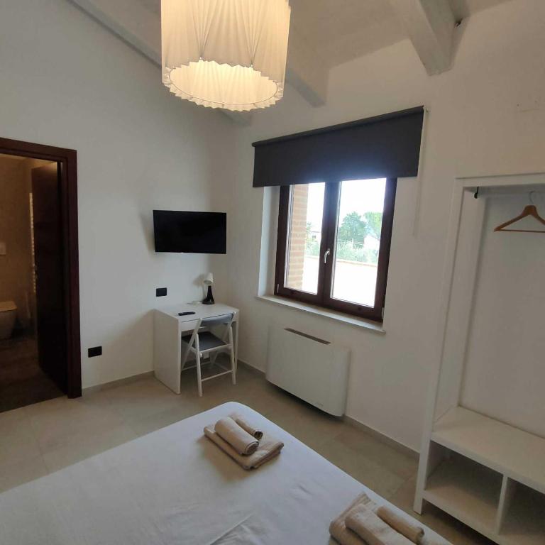 Postel nebo postele na pokoji v ubytování Agriturismo Giorgini