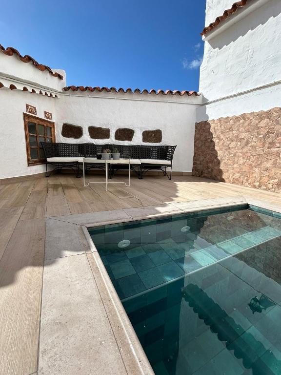 a swimming pool in front of a house at Casa Mari in Agaete