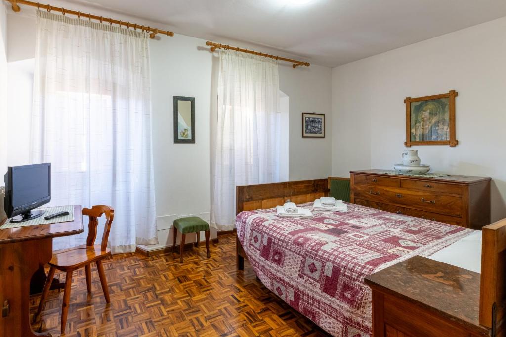 Postel nebo postele na pokoji v ubytování Albergo Alle Alpi