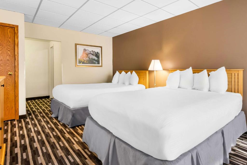 a hotel room with two large beds in it at Best Western Lee's Motor Inn in Chamberlain